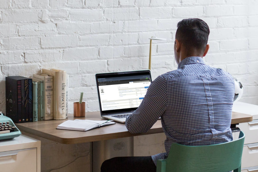 A marketing team member engaged in a Drupal training video on their computer.