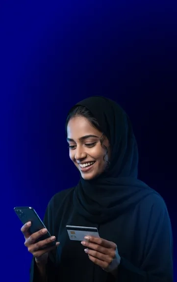 Smiling bank customer using a mobile banking app and payment card, highlighting bank website marketing, mobile responsiveness, and user-friendly mobile design.